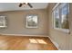Bright living room with hardwood floors and multiple windows allowing natural light to fill the space at 1658 Winona Ct, Denver, CO 80204