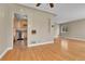 Open living room with hardwood floors flowing into the adjacent kitchen, creating a seamless living space at 1658 Winona Ct, Denver, CO 80204