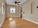 Comfortable living room featuring hardwood floors, a ceiling fan, and large windows for ample natural light at 1658 Winona Ct, Denver, CO 80204