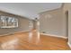 Spacious living room with hardwood floors, large windows, and a ceiling fan providing comfort and style at 1658 Winona Ct, Denver, CO 80204