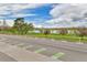 Scenic street view near a park with mature trees, a lake, and a bike lane at 1658 Winona Ct, Denver, CO 80204