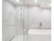 Modern bathroom featuring marble tile, a glass-enclosed shower, and a freestanding tub at 2320 N Lafayette St, Denver, CO 80205