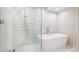 Modern bathroom featuring marble tile, a glass-enclosed shower, and a freestanding tub at 2320 N Lafayette St, Denver, CO 80205