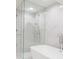 Modern bathroom featuring marble tile, a glass-enclosed shower, and a freestanding tub at 2320 N Lafayette St, Denver, CO 80205