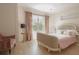 Bright bedroom with pink accents, including velvet chair and bedding at 2320 N Lafayette St, Denver, CO 80205