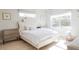 Bright bedroom with a white bed and neutral toned furniture at 2320 N Lafayette St, Denver, CO 80205