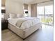 Bright bedroom with a large bed, neutral colors, and balcony access at 2320 N Lafayette St, Denver, CO 80205