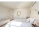 Bright bedroom featuring neutral decor, a unique mirror, and light wood floors at 2320 N Lafayette St, Denver, CO 80205