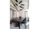 Contemporary dining room with modern light fixture, long table, and black chairs and hardwood flooring at 2320 N Lafayette St, Denver, CO 80205