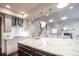 Bright kitchen featuring stainless appliances, granite countertops, a center island and stairs to the upper level at 2320 N Lafayette St, Denver, CO 80205