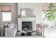 Bright living room featuring fireplace, comfortable seating, decorative items, and an indoor plant at 2320 N Lafayette St, Denver, CO 80205