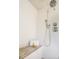 Bright walk-in shower with white tile, chrome fixtures, and a built in bench at 2320 N Lafayette St, Denver, CO 80205