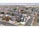 Aerial view of house and surrounding neighborhood in winter at 9790 Moss Rose Cir, Highlands Ranch, CO 80129