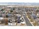 Aerial view of house and surrounding neighborhood in winter at 9790 Moss Rose Cir, Highlands Ranch, CO 80129