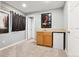 Basement wet bar with sink, mini-fridge, and wood cabinets at 9790 Moss Rose Cir, Highlands Ranch, CO 80129