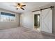 Main bedroom with barn door entry to ensuite bathroom at 9790 Moss Rose Cir, Highlands Ranch, CO 80129