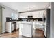 Modern kitchen with white cabinets, stainless steel appliances, and a kitchen island at 9790 Moss Rose Cir, Highlands Ranch, CO 80129