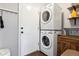 Laundry room with stacked washer and dryer, plus extra shelving at 9790 Moss Rose Cir, Highlands Ranch, CO 80129