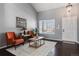 Inviting living room with hardwood floors, large windows, and comfortable seating area at 9790 Moss Rose Cir, Highlands Ranch, CO 80129