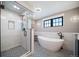 Elegant bathroom showcasing modern shower, sleek tub, and decorative tiled floor at 2732 S Jackson St, Denver, CO 80210