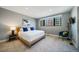Bright bedroom featuring neutral decor, a cozy chair, and a large window offering natural light at 2732 S Jackson St, Denver, CO 80210