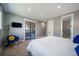 Serene bedroom with a modern accent chair and a view through glass doors at 2732 S Jackson St, Denver, CO 80210