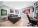 Modern bedroom with a black bed frame, decorative wall art, and a dedicated workspace at 2732 S Jackson St, Denver, CO 80210