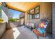 Cozy covered porch with wood-paneled walls, an adirondack chair, and a view of the house exterior at 2732 S Jackson St, Denver, CO 80210