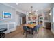 Stylish dining room with modern lighting, wainscoting, and wood floors open to other living spaces at 2732 S Jackson St, Denver, CO 80210