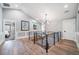 Bright hallway featuring hardwood floors, modern railing, and contemporary lighting fixture at 2732 S Jackson St, Denver, CO 80210