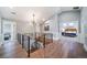 Bright hallway featuring hardwood floors, modern railing, and access to bedrooms at 2732 S Jackson St, Denver, CO 80210