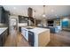 A modern, open kitchen with a large island, stainless steel appliances, and hardwood flooring at 2732 S Jackson St, Denver, CO 80210