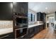 Stylish kitchen with stainless appliances, elegant fixtures, custom cabinets, and tile backsplash at 2732 S Jackson St, Denver, CO 80210