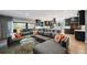 Expansive living room with a large sectional sofa, modern kitchen, and outdoor access for seamless indoor-outdoor living at 2732 S Jackson St, Denver, CO 80210