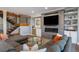 Well-lit living room with a sectional sofa, fireplace, and decorative wall art, creating a comfortable and inviting space at 2732 S Jackson St, Denver, CO 80210