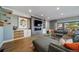 Comfortable living room with modern furnishings, a fireplace, a large television, and access to the backyard at 2732 S Jackson St, Denver, CO 80210