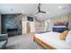 Main bedroom featuring a stone fireplace, TV, neutral tones, and seating at 2732 S Jackson St, Denver, CO 80210