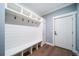 Functional mudroom with a built-in bench, storage, hooks, and wood flooring at 2732 S Jackson St, Denver, CO 80210