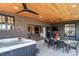 Inviting outdoor patio with a hot tub, dining set, and covered area with a ceiling fan at 2732 S Jackson St, Denver, CO 80210