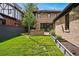 Manicured backyard featuring a brick home exterior and green grass at 1050 S Gilpin St, Denver, CO 80209