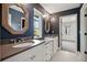 Bathroom with dual sink vanity, decorative mirrors, and hexagonal tile floor at 1050 S Gilpin St, Denver, CO 80209