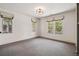 Minimalist bedroom with three windows providing natural light, and neutral carpet at 1050 S Gilpin St, Denver, CO 80209