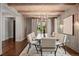 Dining room with modern chandelier and seating for eight at 1050 S Gilpin St, Denver, CO 80209