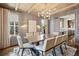 Dining room with modern chandelier, gray wallpaper and seating for eight at 1050 S Gilpin St, Denver, CO 80209
