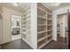 Hallway featuring custom built-in shelving and views into the primary bathroom and bedroom at 1050 S Gilpin St, Denver, CO 80209