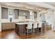 Well-designed kitchen featuring an island with seating, grey cabinetry, and hardwood floors at 1050 S Gilpin St, Denver, CO 80209