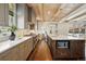 Spacious kitchen with stainless steel appliances, an island, and wood floors, with an eat-in area at 1050 S Gilpin St, Denver, CO 80209