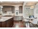 Charming kitchen with grey cabinets, marble countertops, a breakfast nook, and hardwood floors at 1050 S Gilpin St, Denver, CO 80209