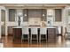 Beautiful kitchen with an island, grey cabinets, white subway tiles, and modern stainless steel appliances at 1050 S Gilpin St, Denver, CO 80209