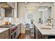 Modern kitchen with a stainless steel range, a marble island, and an adjacent breakfast nook at 1050 S Gilpin St, Denver, CO 80209